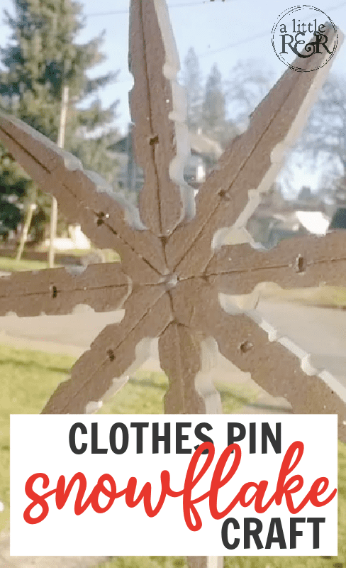 picture of a clothes pin snowflake hanging in a window