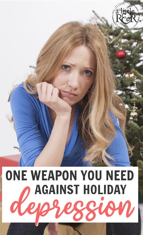 Depressed woman sitting in front of Christmas tree