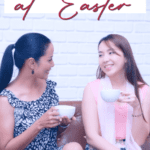 Two women walking and drinking coffee
