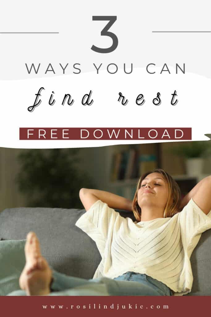 Woman in white t-shirt sitting on couch with hands behind her head and feet up on the coffee table