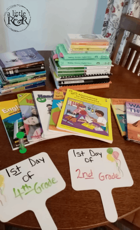 homeschool curriculum and supplies on a kitchen table