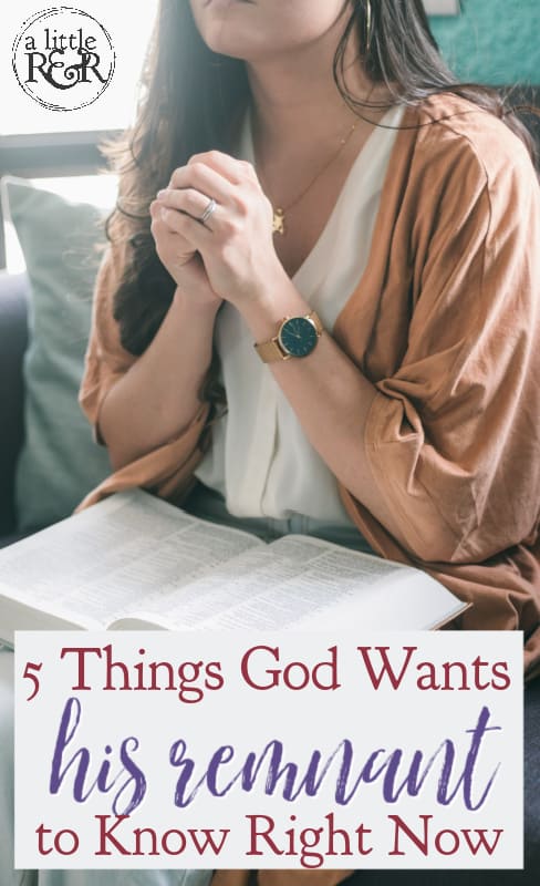 person praying with bible on lap