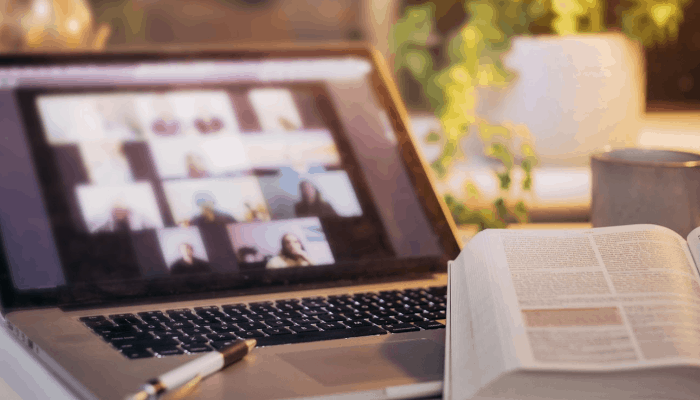 Bible open on laptop, zoom church meeting