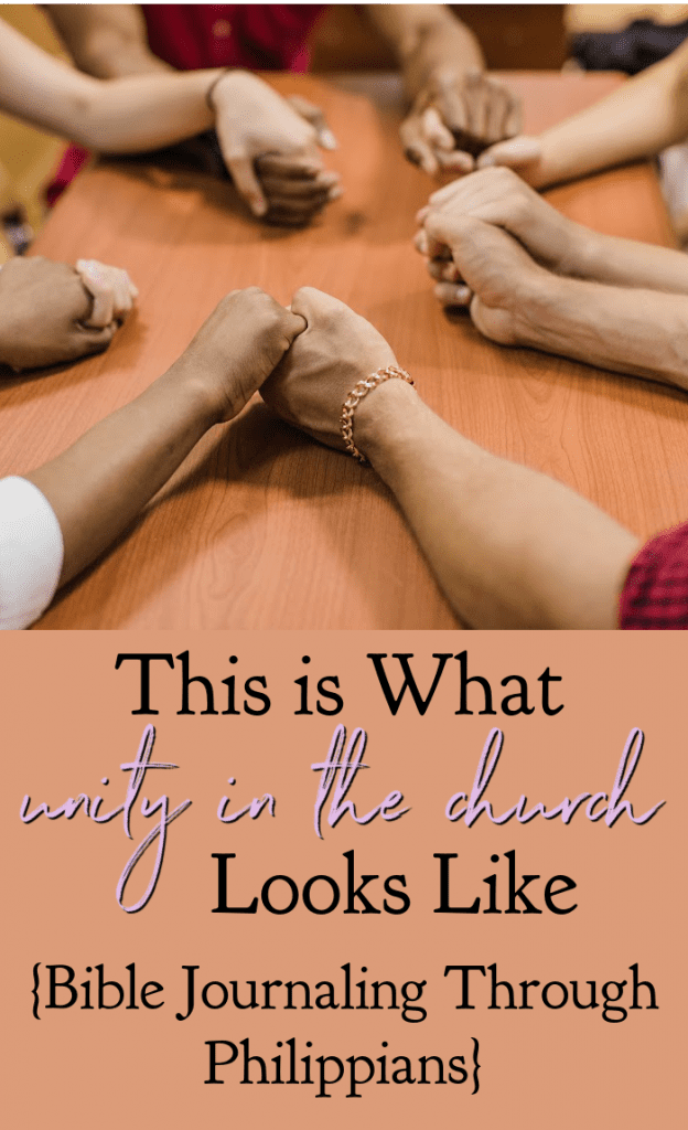 People in a circle holding hands in prayer