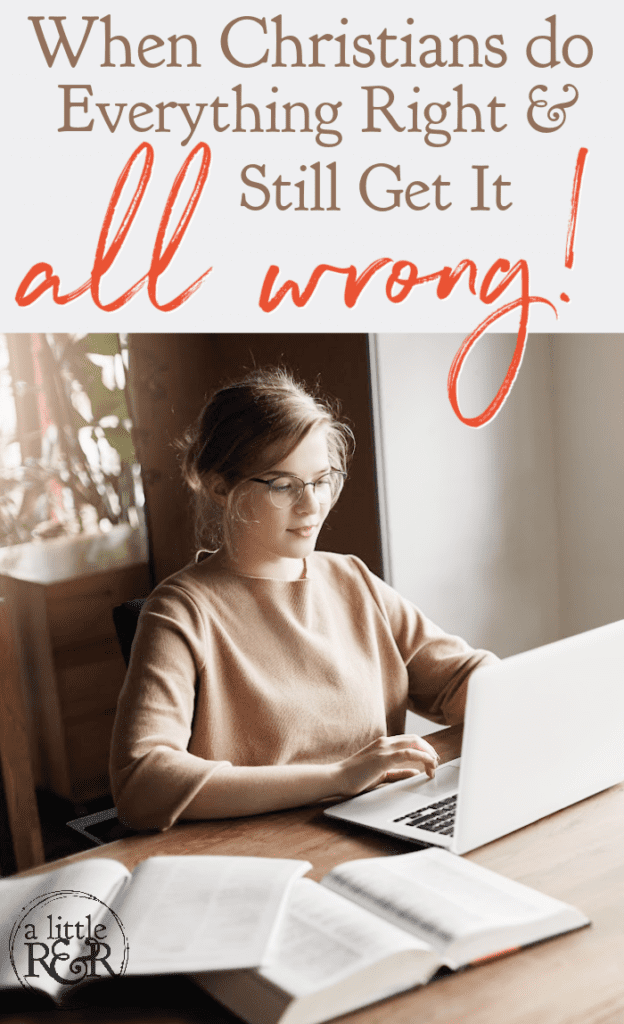 woman sitting at table typing on laptop with books opened beside her