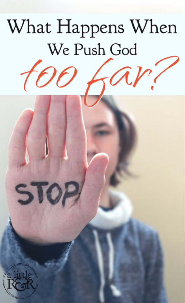 person holding up hand with the word stop written on palm