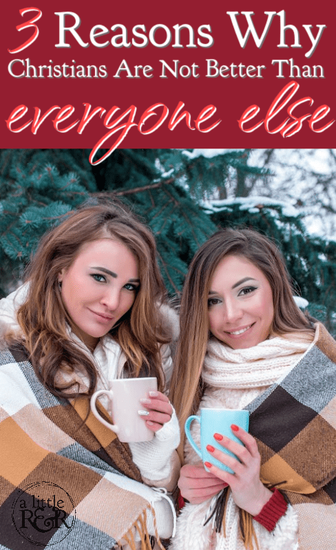 Two girls wrapped in plaid blanket drinking coffee