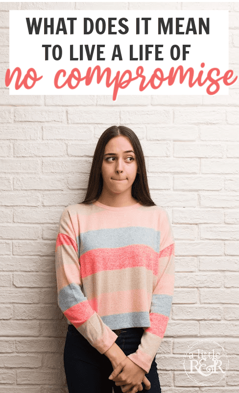 girl in striped sweater standing against a white brick wall