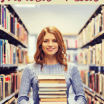 woman in library holding a stack of books