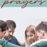 group of people in a circle hands on each other's shoulders praying