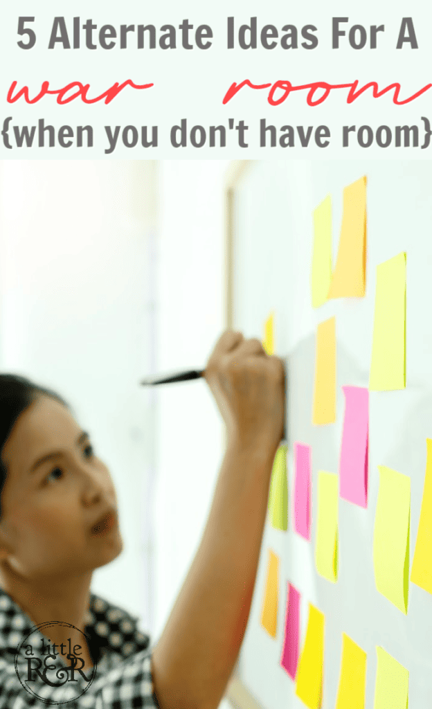 woman writing on post-it notes hanging on a wall