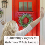 A woman with hands raised praying over home with a red door and lavender wreath