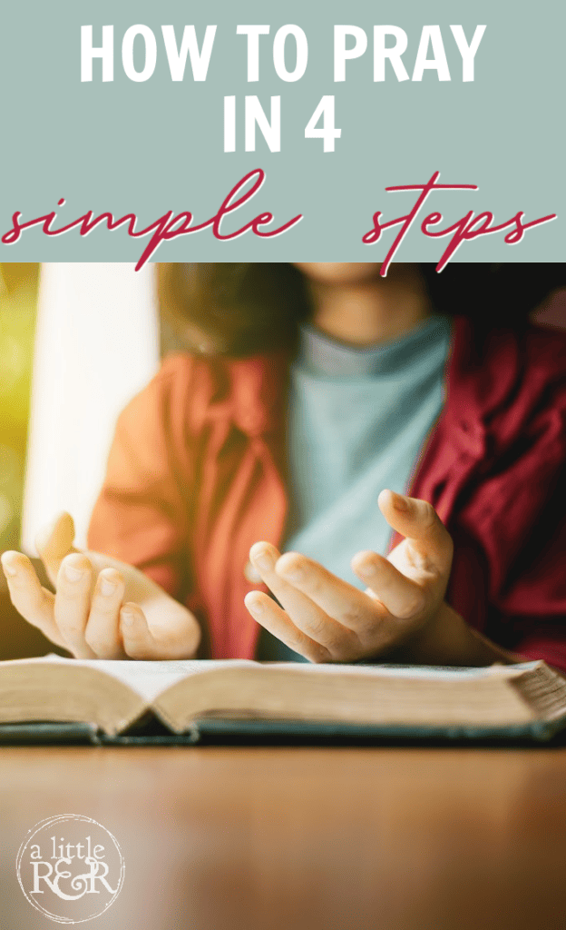 Woman in red shirt with hands laying open on bible praying