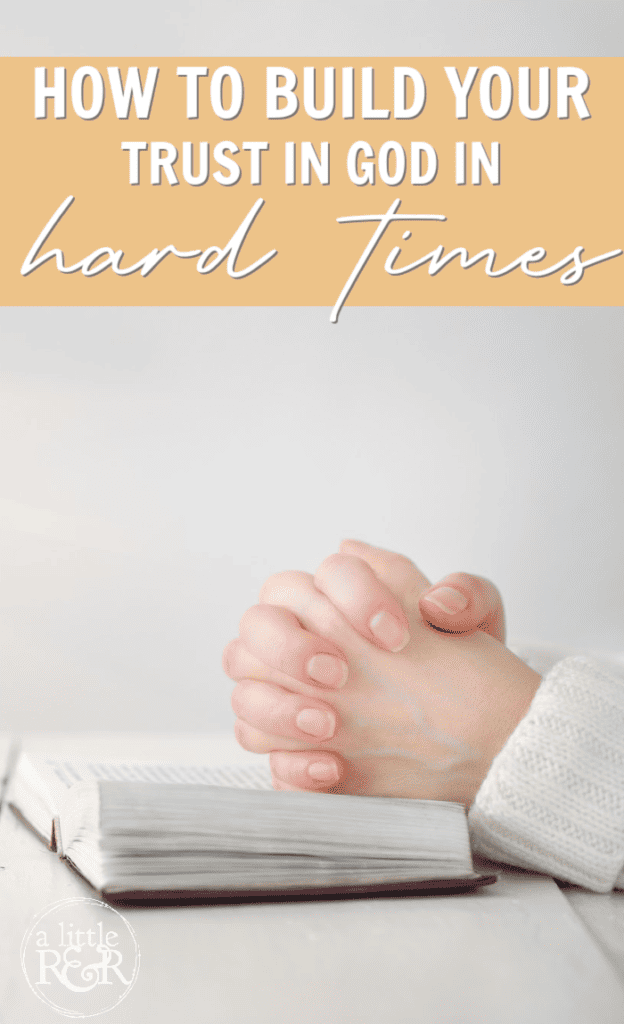 hands folded on a Bible