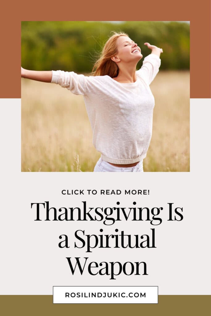 Woman in white dress in field with arms stretched out using thanksgiving as a spiritual weapon