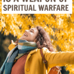 Woman in yellow jacket in the fall happy with arms outstretched