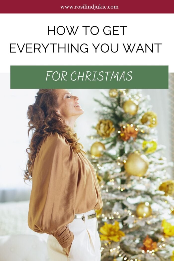 Woman standing by a Christmas tree happy knowing how to get everything you want for Christmas