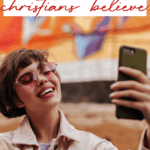 Woman in short hair and sunglasses smiling into phone taking a selfie