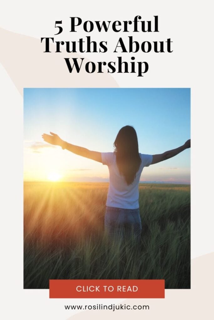 woman in a field with hands raised following the truths about worship