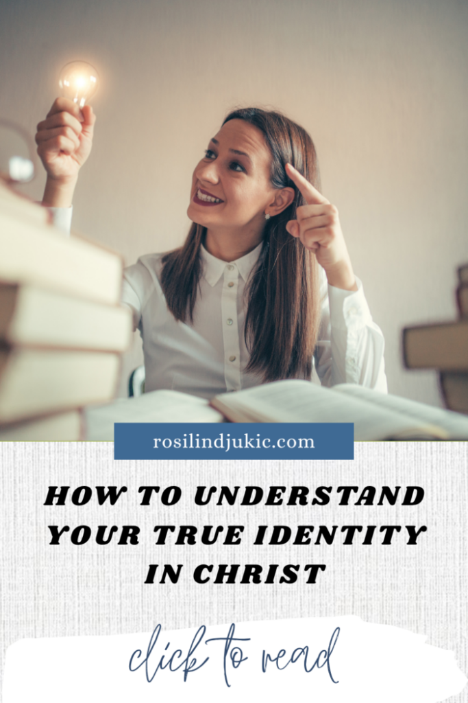 woman discovering identity in Christ sitting at table with books holding a lightbulb